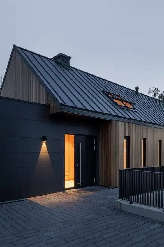 Modern House at Night with Wood Cladding and Metal Roof